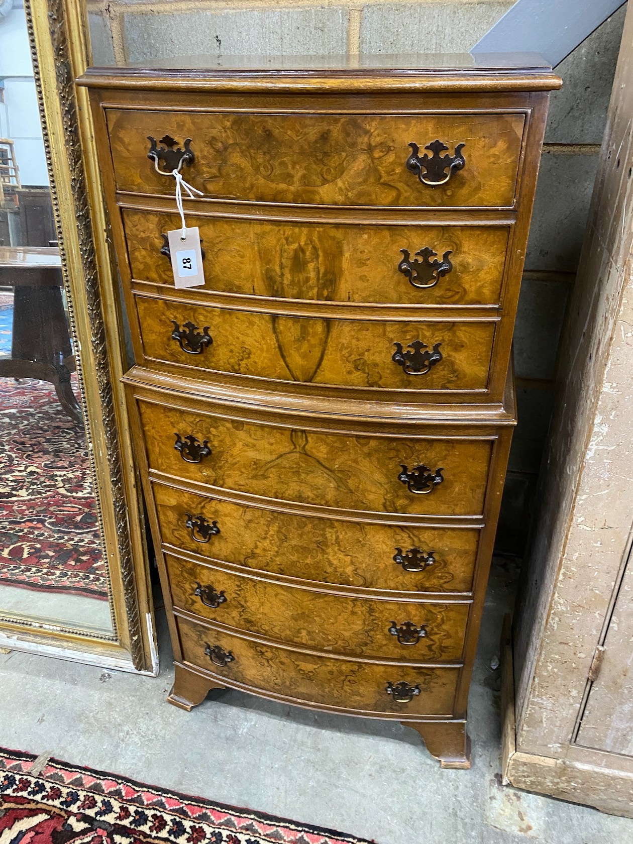 A small Queen Anne style walnut seven drawer bow front chest, width 54cm, depth 38cm, height 110cm